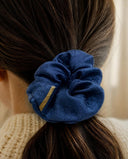 Close-up of the Denim Blue kimono scrunchie worn on a low ponytail