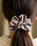 Close-up of the Pink Ditsy Floral kimono scrunchie worn on a low ponytail