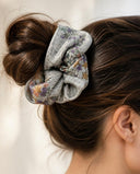 Close-up of the Silver Gray Floral kimono scrunchie worn on a messy bun