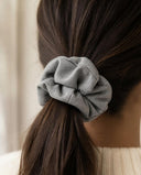 Close-up of the Dove Gray kimono scrunchie worn on a low ponytail