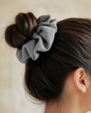 Close-up of the Dove Gray kimono scrunchie worn on a messy bun