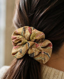 Close-up of the Olive Gold Brocade kimono scrunchie worn on a low ponytail