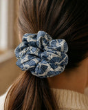 Close-up of the Slate Blue Fan kimono scrunchie worn on a low ponytail