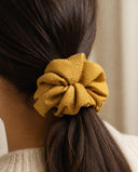 Close-up of the Mustard Yellow kimono scrunchie worn on a low ponytail