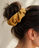 Close-up of the Mustard Yellow kimono scrunchie worn on a messy bun
