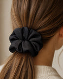 Close-up of the Deep Charcoal kimono scrunchie worn on a low ponytail