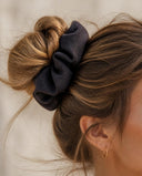 Close-up of the Deep Charcoal kimono scrunchie worn on a messy bun