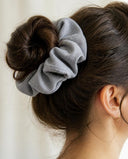 Close-up of the Blue Gray kimono scrunchie worn on a messy bun