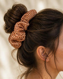 Close-up of the Amber Shibori kimono scrunchie worn on a messy bun