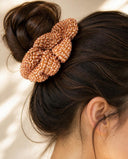 Close-up of the Orange Kanoko Shibori kimono scrunchie worn on a messy bun