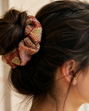 Close-up of the Rust Autumn Floral kimono scrunchie worn on a messy bun