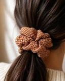 Close-up of the Amber Shibori kimono scrunchie worn on a low ponytail