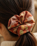 Close-up of the Rust Autumn Floral kimono scrunchie worn on a low ponytail