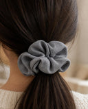 Close-up of the Blue Gray kimono scrunchie worn on a low ponytail