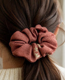 Close-up of the Rosewood Floral Accent kimono scrunchie worn on a low ponytail