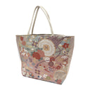 Rosewood Wheels obi bag made from a vintage Japanese obi, with lattice roundels tied with red cords, carriage wheels and flowers on dusty rose